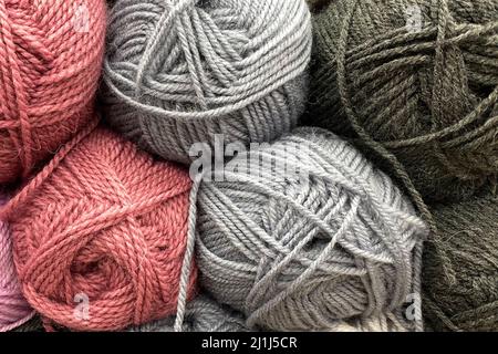 Yarn in skeins. Wool yarn of gray and pink colors lies tightly next to each other Stock Photo