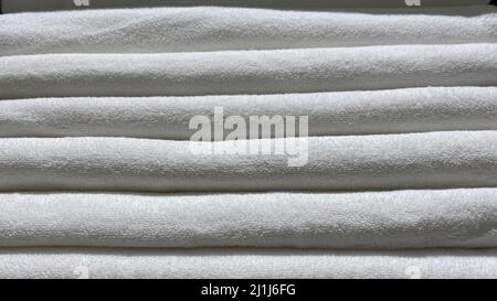 White Towels. A stack of folded cotton terry towels in close-up. Stock Photo