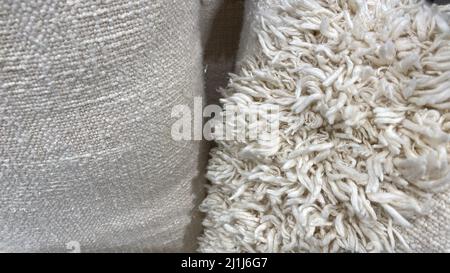 The texture of the carpet for the house is made of natural material. Long-pile fabric. Natural linen color Stock Photo