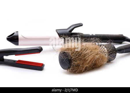Metal round hairbrush with a clump of hair and different electronic tools for styling Stock Photo