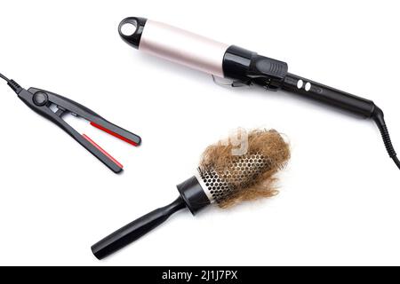 Metal round hairbrush with a clump of hair and different electronic tools for styling Stock Photo