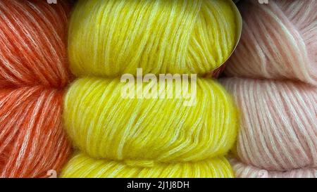 Yellow-orange range of wool yarn. Multicolored skeins of wool close-up Stock Photo