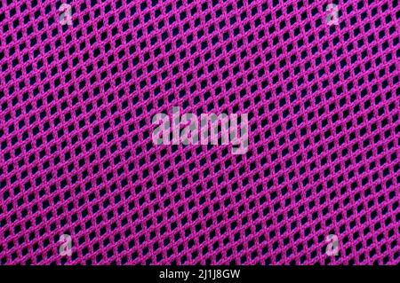 The background is made of luxurious purple or violet fabric with a mesh structure. Fabric, lining material with straight intersecting lines. pattern Stock Photo