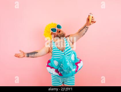 Fat man with beard and life buoy for children eats an icecream Stock Photo