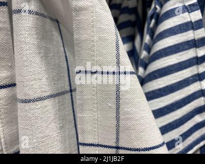 white material made of natural cotton. blue striped and checkered fabric Stock Photo