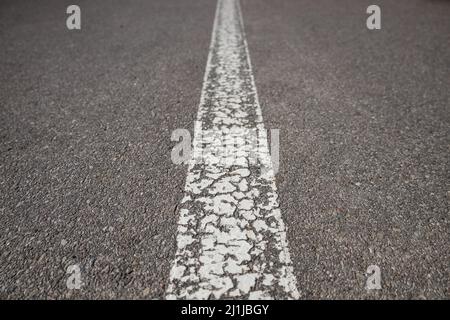 Asphalt road with single solid white line road marking Stock Photo
