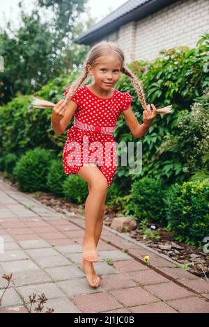 Funny little girl with pigtails jumping on a small trampoline Stock ...