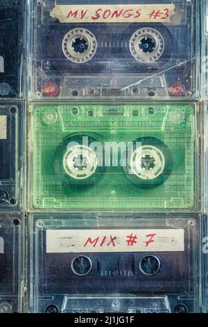 Transparent cassette tapes arranged in a grid on blue sofa Stock Photo