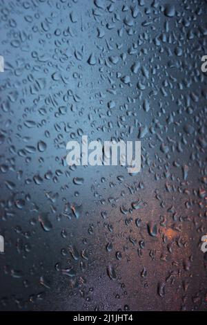 raindrops on glass in cold weather in the evening Stock Photo