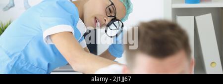Female doctor looking at the body of a male patient Stock Photo