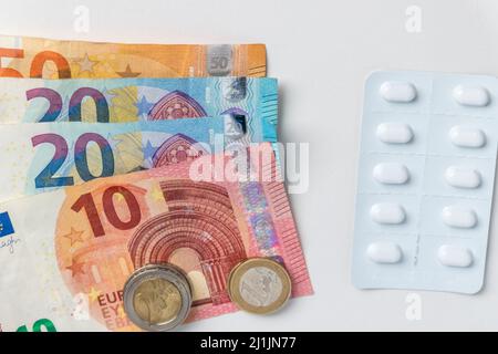 Expensive medical treatment represented by euro money and euro bank notes cash for pills, drugs and medical research of tablets and medicaments drug Stock Photo