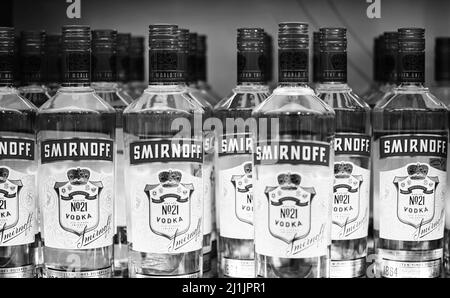 Russian vodka. Bottles of Smirnoff vodka on a shelf in duty free shop in Dubai Airport. Traditional Russian souvenir. 12,02,2022, Dubai, UAE Stock Photo