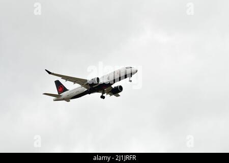 A passenger airplane lands at Pearson international airport in Toronto Canada in cloudy weather Stock Photo