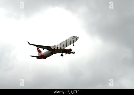 A passenger airplane lands at Pearson international airport in Toronto Canada in cloudy weather Stock Photo