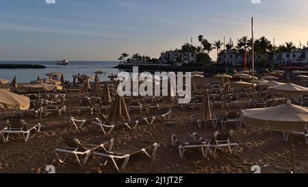 Beautiful view of the beach of small fishing village Puerto de Mogan in the south of Gran Canaria island, Spain, in the evening sunlight. Stock Photo