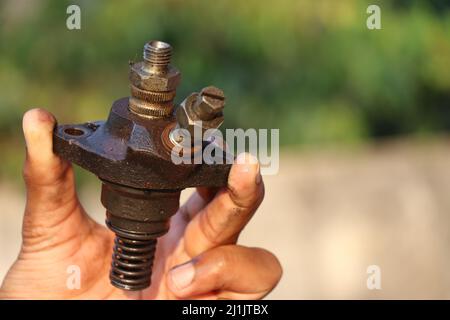 A fuel injector that supplies fuel to the combustion chamber of internal combustion diesel-powered engines held in the hand Stock Photo