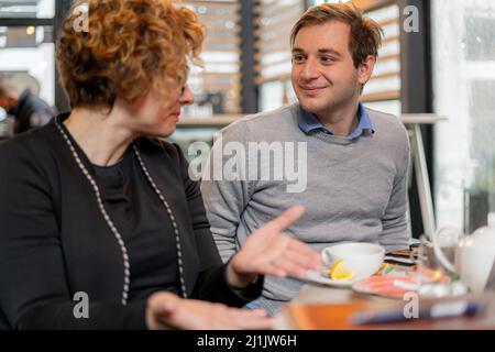 Amazing and beautiufl businesspeople are having a discussion and smiling Stock Photo