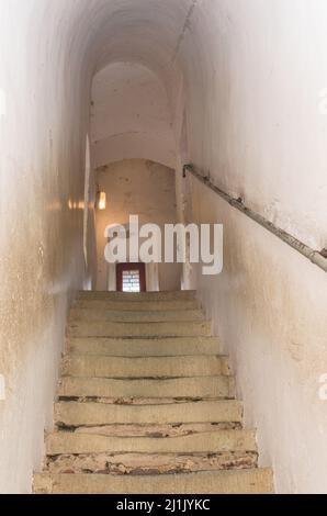 Narrow steep stairs of stone inside a medieval building. Stock Photo