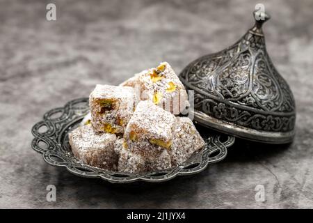 Turkish delight with pistachio on a dark background. close up Stock Photo