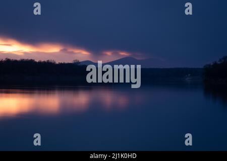 Mountain Motajica obscured by dark clouds at twilight in long exposure - landscape Stock Photo
