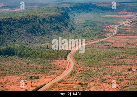 Aerial view of a shrub-covered ridge of the Great Rift Valley, paralleled by a main road leading north towards Nairobi, Kenya Stock Photo