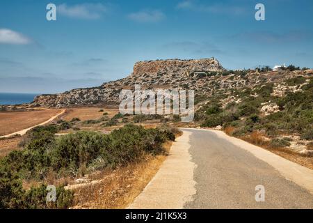 Landscape road to Cape Greco peninsula, Cyprus. It is mountainous peninsula with a national park, rock paths, a turquoise lagoon and a natural stone b Stock Photo