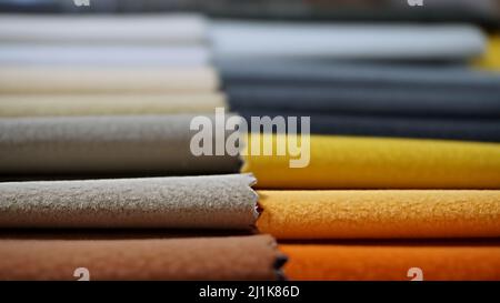 Close-up colorful upholstery fabric samples background. Example for fabric catalog. Selective focus. Stock Photo