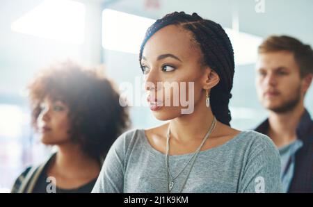 Building their business on ambition and drive. Shot of a group of ambitious young colleagues in a modern office. Stock Photo