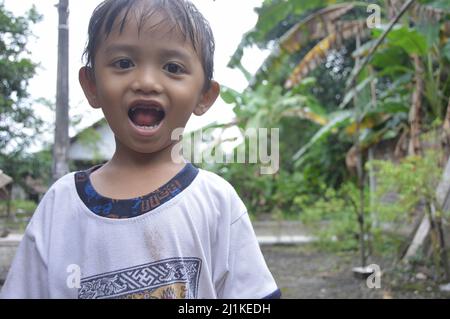 a small child showing his missing teeth Stock Photo