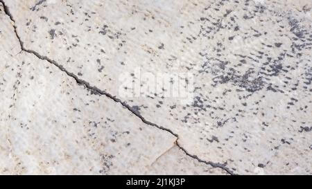 Cracked antique marble texture. Weather-cracked stone wall. Marble stone texture Stock Photo