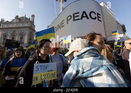 London, UK. 26th Mar, 2022. London Stands with Ukraine march in London at Piccadilly Circus where Yoko Ono's Imagine Peace was displayed in support of Ukraine against the Russian invasion and war. Credit: Andy Sillett/Alamy Live News Stock Photo