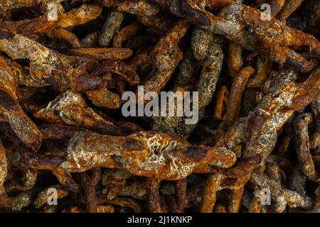 Close-up of rusted metal chains from a ship's anchor. Background image with nautical theme Stock Photo