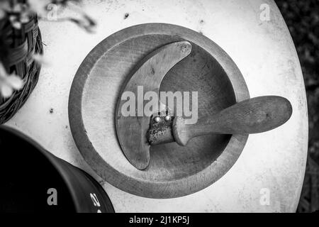 A top greyscale view of a wooden bowl and a cutter with handle Stock Photo