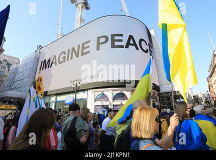 London, UK. 26th March 2022.  Thousands joined a march in support of Ukraine on Saturday as Mayor Sadiq Khan urged the UK to do much more to help Ukainians. The march went through Piccadilly Circus where Yoko Ono's famous phrase 'Imagine Peace' was  displayed. Credit : Monica Wells/Alamy Live News Stock Photo