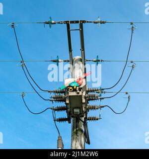 Electricity distribution 3 phase high voltage circuit breaker isolator switch in OFF position used to disconnect power supply on overhead cables. UK Stock Photo