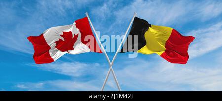 two crossed flags canada and Belgium waving in wind at cloudy sky. Concept of relationship, dialog, travelling between two countries. 3d illustration Stock Photo