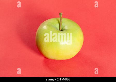 white apple on red background Stock Photo