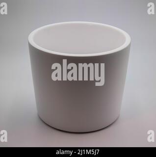 White planter pot for large plant to go in. Made of ceramic, in front of white background. Stock Photo