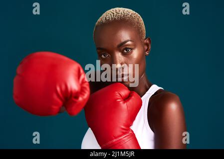 Image of beautiful serious woman wearing sportive clothes training in  boxing gloves by seaside in morning Stock Photo - Alamy