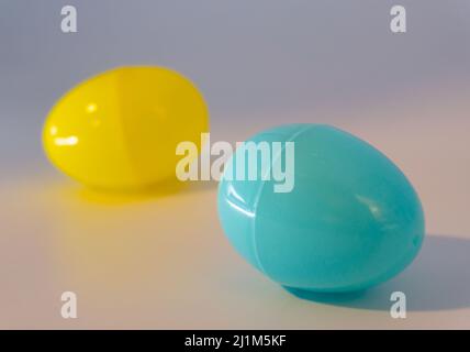 Blue and yellow easter eggs. Made of plastic in front of white background. Stock Photo