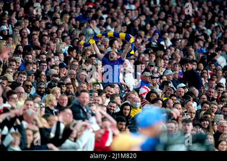 An England fan in the stands holds up a scarf in the colours of the Ukraine flag during the Alzheimer's Society international match at Wembley Stadium, London. Picture date: Saturday March 26, 2022. Stock Photo