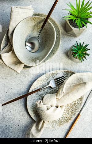 Minimalistic table setting on concrete background Stock Photo