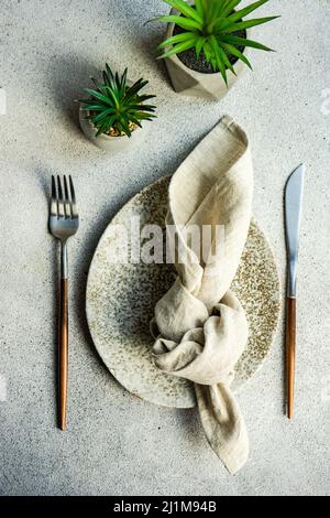 Minimalistic table setting on concrete background Stock Photo