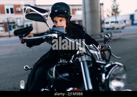 Woman on a motorcycle with a gun in her hands Stock Photo