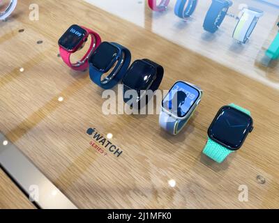 Paris, France - Mar 18, 2022: Row of multiple colorful Apple Computers Watch Series 7 smart IOT devices with multiple colorful bands and screens at the Apple Inc. flagship store Stock Photo