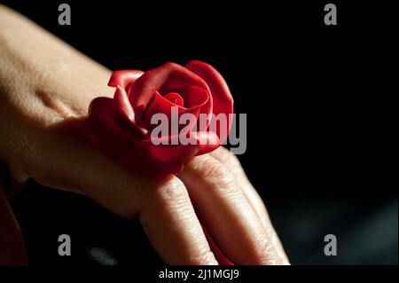 Ceramic Rose on a woman hand Stock Photo