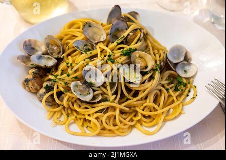 Italian sea food dinner first course pasta with clams alle vongole ready to eat Stock Photo