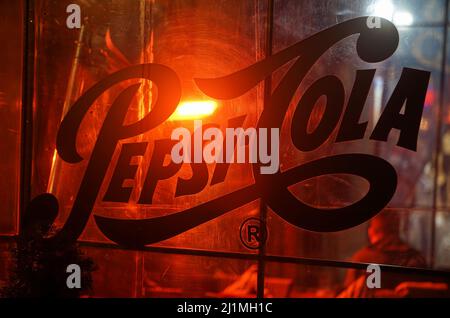 Bucharest, Romania - December 03, 2021: Pepsi-Cola commercial on the transparent wall of a restaurant in the old center of Bucharest. Stock Photo