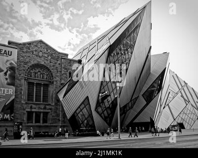 TORONTO, CANADA - 08 05 2011: Black and white image of famous modern Royal Ontario Museum buildig walking in front in a sunny day in Toronto on August Stock Photo