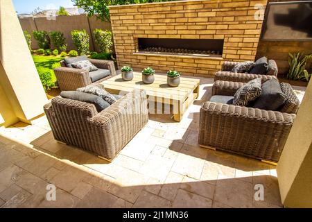 Four Oversize Wicker Chairs In Rear Yard Setting Stock Photo